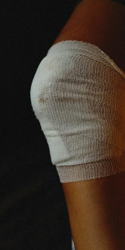 Person with Medical Gauze Bandage on Injured Knee